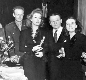 A flag hangs behind Oscar winners in 1943, including Van Heflin (left), who wore his military uniform to the ceremonies