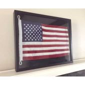 Framed American flag on shelf